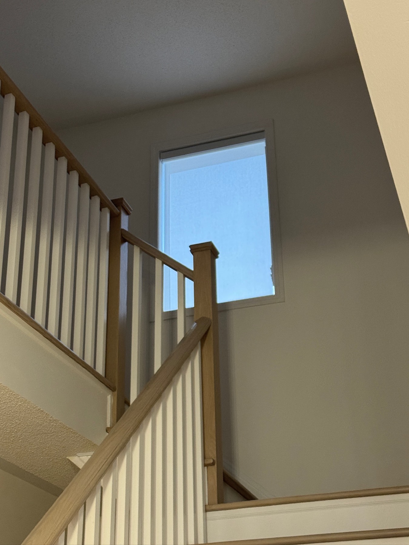 Roller shade on a high stairwell window that cannot be reached from the floor
